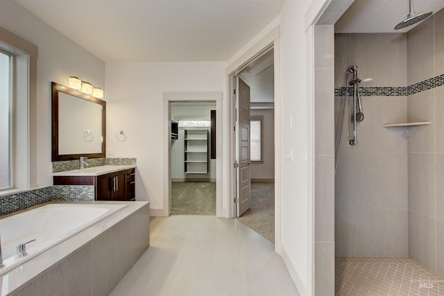 bathroom featuring shower with separate bathtub and vanity