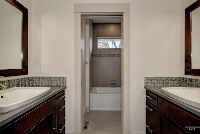 bathroom featuring tile patterned flooring, vanity, and a washtub