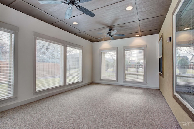 unfurnished room with carpet, plenty of natural light, and ceiling fan