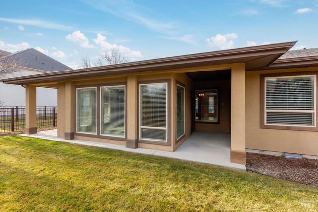 rear view of property featuring a yard