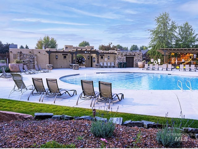 view of pool featuring a pergola and a patio