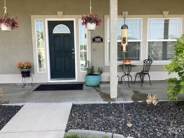 11565 W Zachery Ave, Nampa, ID 83651 - view of exterior entry with stucco siding and covered porch