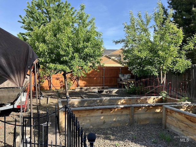 11565 W Zachery Ave, Nampa, ID 83651 - fenced backyard featuring a vegetable garden