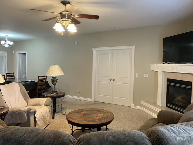 11565 W Zachery Ave, Nampa, ID 83651 - living room with light carpet, a ceiling fan, baseboards, a tiled fireplace, and a chandelier