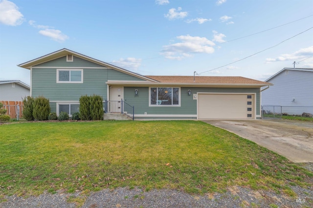 split level home featuring a front yard and a garage