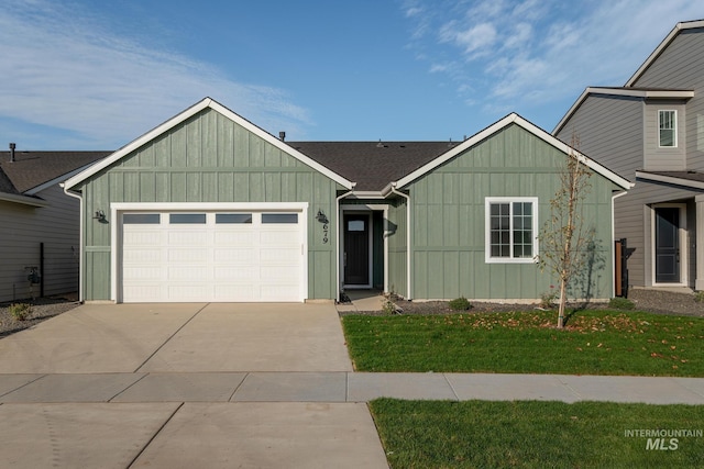 2267 W Blue Lightning Ct, Middleton, ID 83644 - view of front of home with concrete driveway, a garage, a front yard, and board and batten siding