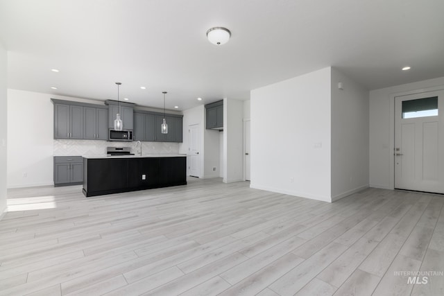 2267 W Blue Lightning Ct, Middleton, ID 83644 - kitchen featuring appliances with stainless steel finishes, gray cabinets, decorative backsplash, recessed lighting, and light countertops