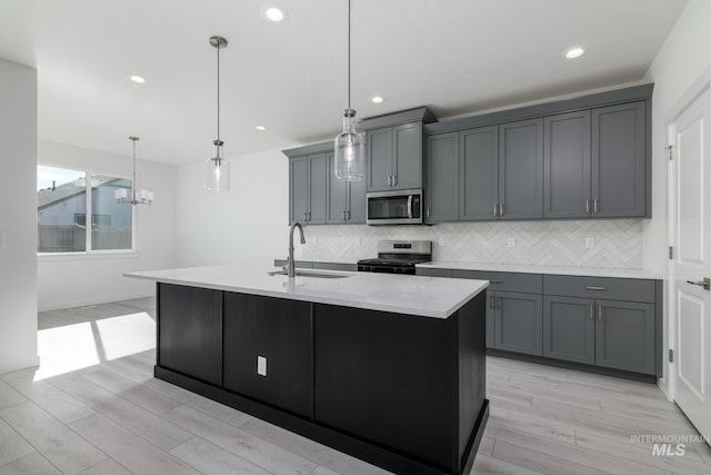 2267 W Blue Lightning Ct, Middleton, ID 83644 - kitchen featuring appliances with stainless steel finishes, a sink, decorative backsplash, recessed lighting, and light wood-type flooring