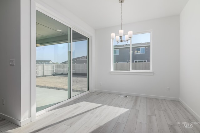 2267 W Blue Lightning Ct, Middleton, ID 83644 - spare room featuring a chandelier, wood finished floors, and baseboards