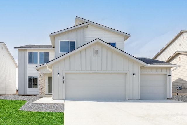 2351 W Opalite Dr, Kuna, ID 83634 - view of front of house featuring board and batten siding, an attached garage, and driveway