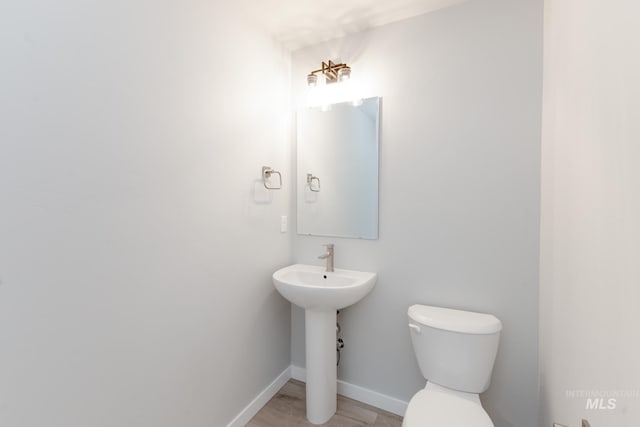2351 W Opalite Dr, Kuna, ID 83634 - bathroom with toilet, baseboards, a sink, and wood finished floors