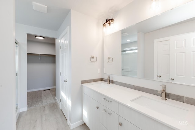 2351 W Opalite Dr, Kuna, ID 83634 - bathroom with an enclosed shower, wood finished floors, double vanity, and a spacious closet