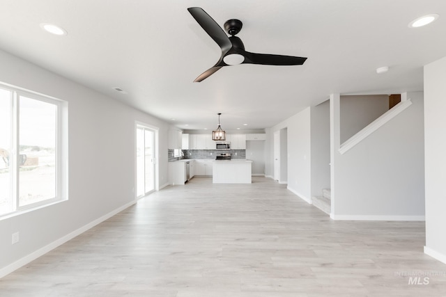 2351 W Opalite Dr, Kuna, ID 83634 - unfurnished living room featuring a ceiling fan, recessed lighting, baseboards, and light wood-type flooring