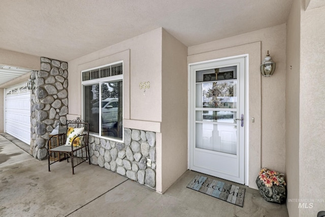 property entrance with stone siding and stucco siding