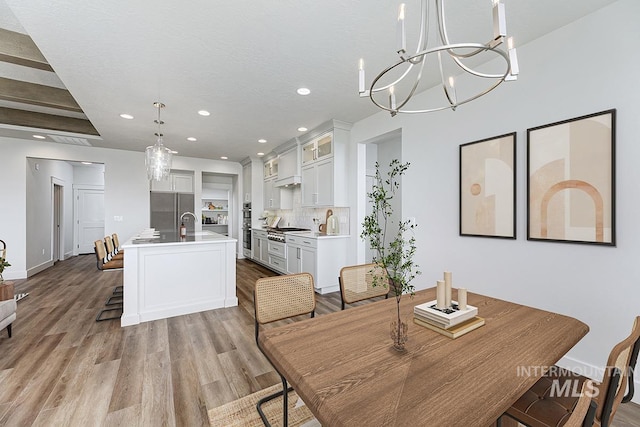 7029 S Tindaris Ave, Meridian, ID 83642 - dining room featuring recessed lighting, light wood-style flooring, and a chandelier