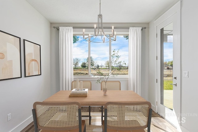 7029 S Tindaris Ave, Meridian, ID 83642 - dining room with a chandelier and plenty of natural light