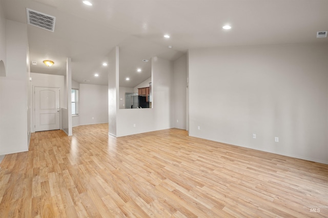 unfurnished living room featuring lofted ceiling, visible vents, recessed lighting, and light wood-style floors