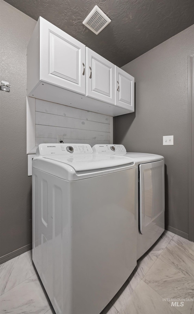 4064 N Alester Ave, Meridian, ID 83646 - laundry room featuring independent washer and dryer, light marble finish floors, cabinet space, and baseboards