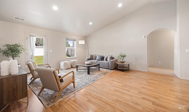 4064 N Alester Ave, Meridian, ID 83646 - living area featuring arched walkways, light wood finished floors, recessed lighting, baseboards, and high vaulted ceiling