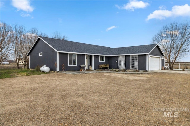 ranch-style home featuring a garage and a front lawn