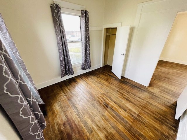 unfurnished bedroom with hardwood / wood-style floors