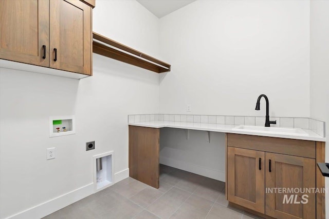 clothes washing area featuring a sink, cabinet space, light tile patterned flooring, hookup for an electric dryer, and hookup for a washing machine