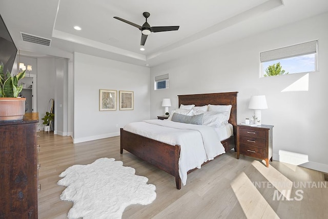 5445 S Mesa Trail Pl, Meridian, ID 83642 - bedroom with a tray ceiling, light wood-style flooring, recessed lighting, baseboards, and a ceiling fan