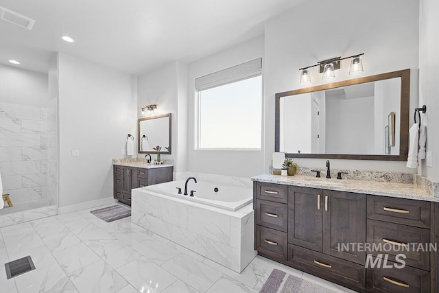 5445 S Mesa Trail Pl, Meridian, ID 83642 - bathroom featuring marble look tile flooring, a bath, two vanities, a tile shower, and recessed lighting