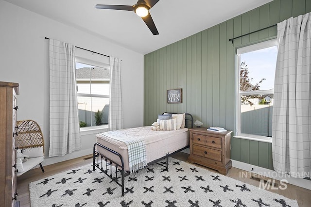 5445 S Mesa Trail Pl, Meridian, ID 83642 - bedroom with multiple windows, wood finished floors, and a ceiling fan