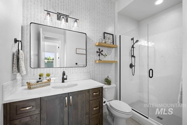 5445 S Mesa Trail Pl, Meridian, ID 83642 - full bathroom featuring toilet, vanity, a shower stall, and decorative backsplash