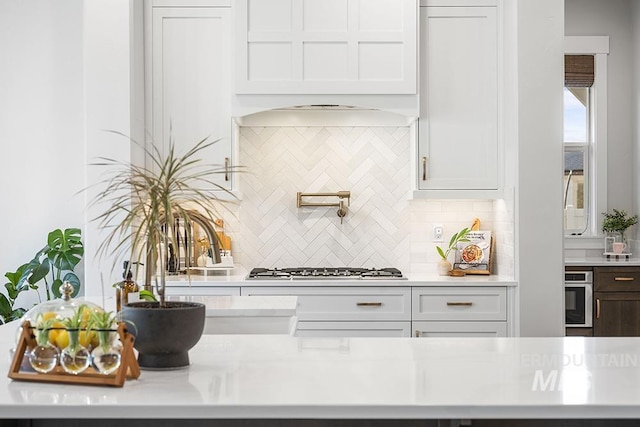 5445 S Mesa Trail Pl, Meridian, ID 83642 - kitchen with light countertops, tasteful backsplash, white cabinetry, and appliances with stainless steel finishes