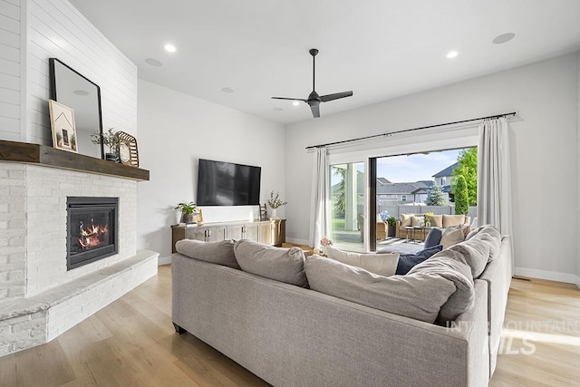 5445 S Mesa Trail Pl, Meridian, ID 83642 - living room with ceiling fan, a brick fireplace, light wood-style floors, baseboards, and recessed lighting