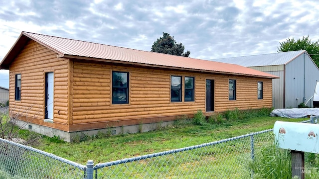 view of side of property with a yard and an outdoor structure