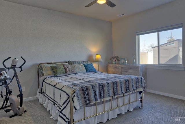 carpeted bedroom with a ceiling fan, visible vents, and baseboards