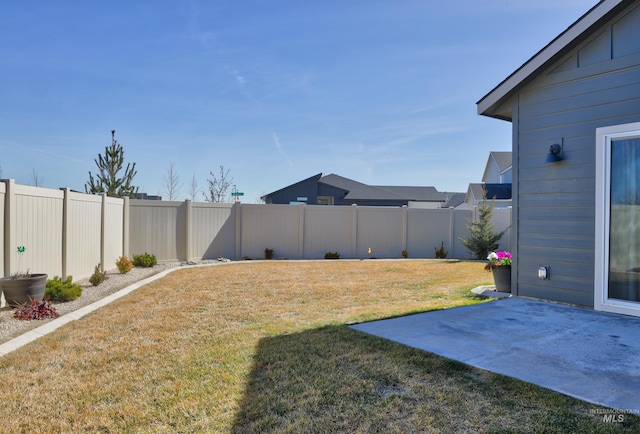 view of yard featuring a patio and a fenced backyard