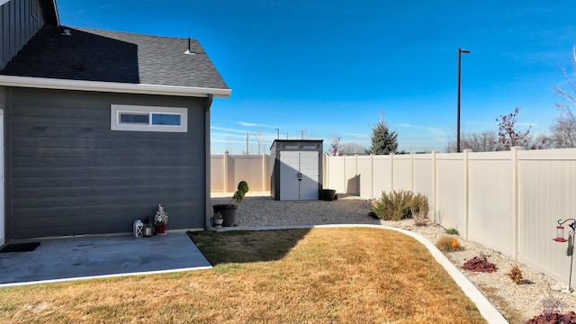 view of yard with an outbuilding, a fenced backyard, a patio, and a storage shed