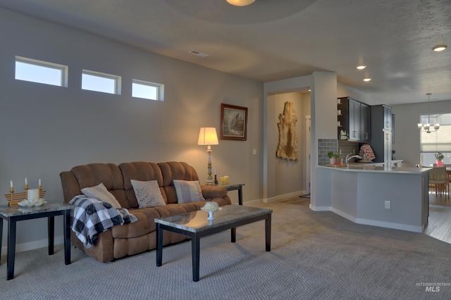 living room featuring recessed lighting, visible vents, light carpet, a chandelier, and baseboards