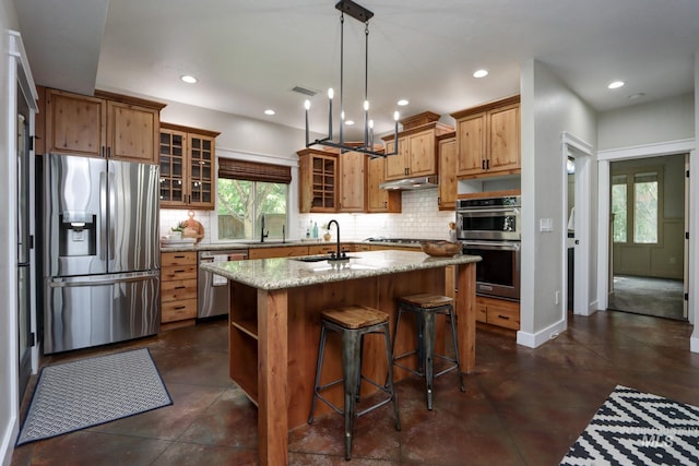 570 E Ocelot, Meridian, ID 83646 - kitchen featuring appliances with stainless steel finishes, a sink, finished concrete flooring, tasteful backsplash, and recessed lighting
