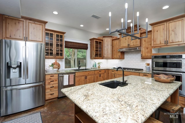 570 E Ocelot, Meridian, ID 83646 - kitchen featuring appliances with stainless steel finishes, a sink, a breakfast bar area, light stone countertops, and recessed lighting