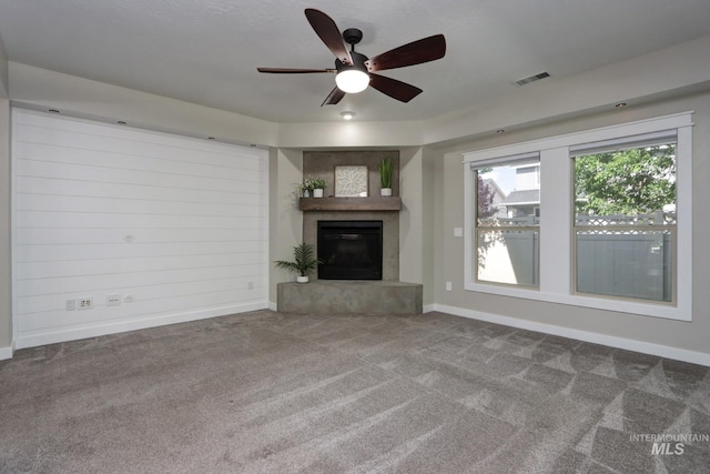 570 E Ocelot, Meridian, ID 83646 - unfurnished living room featuring carpet floors, a glass covered fireplace, and ceiling fan