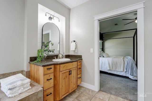 570 E Ocelot, Meridian, ID 83646 - ensuite bathroom featuring vanity, ceiling fan, tile patterned floors, and baseboards