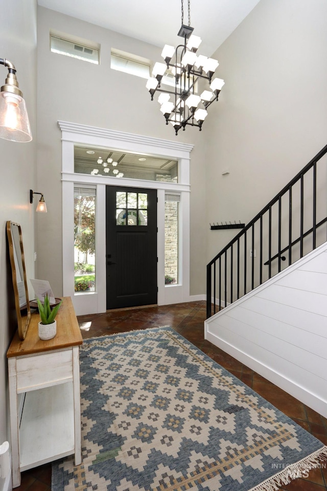 570 E Ocelot, Meridian, ID 83646 - tiled foyer entrance with a chandelier, stairs, a high ceiling, and baseboards