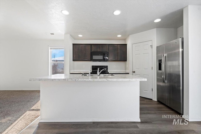 kitchen featuring a kitchen island with sink, stainless steel fridge with ice dispenser, dark brown cabinets, and sink