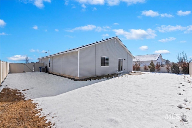 view of snow covered rear of property