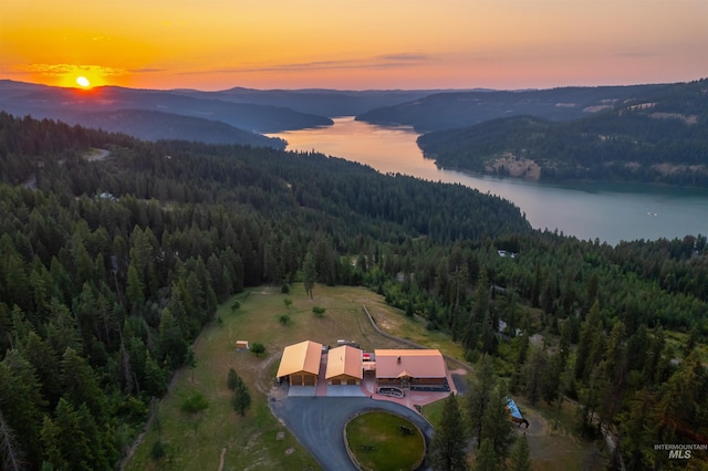 aerial view at dusk of a forest view and a water and mountain view