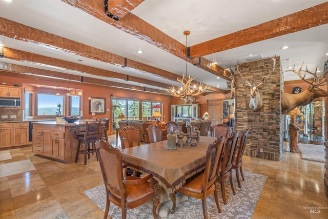 dining room with a chandelier, recessed lighting, and beamed ceiling