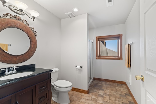 bathroom featuring baseboards, stone finish flooring, a shower stall, and vanity