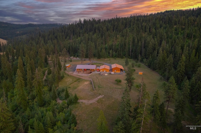aerial view of property's location with a forest