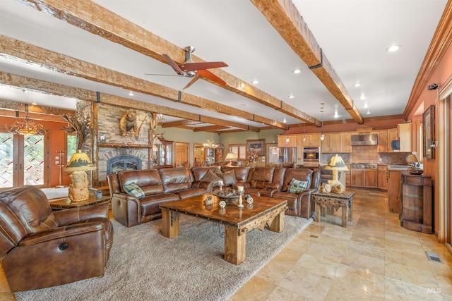 living area with beam ceiling, healthy amount of natural light, a fireplace, recessed lighting, and a ceiling fan