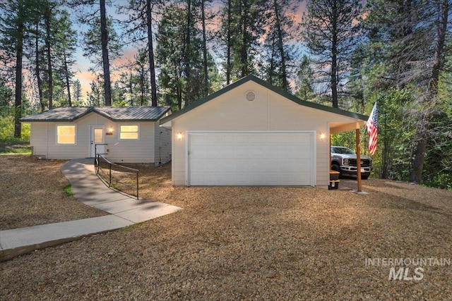 104 Sky Ridge Dr, Garden Valley, ID 83622 - view of front facade featuring an outdoor structure, a garage, and metal roof